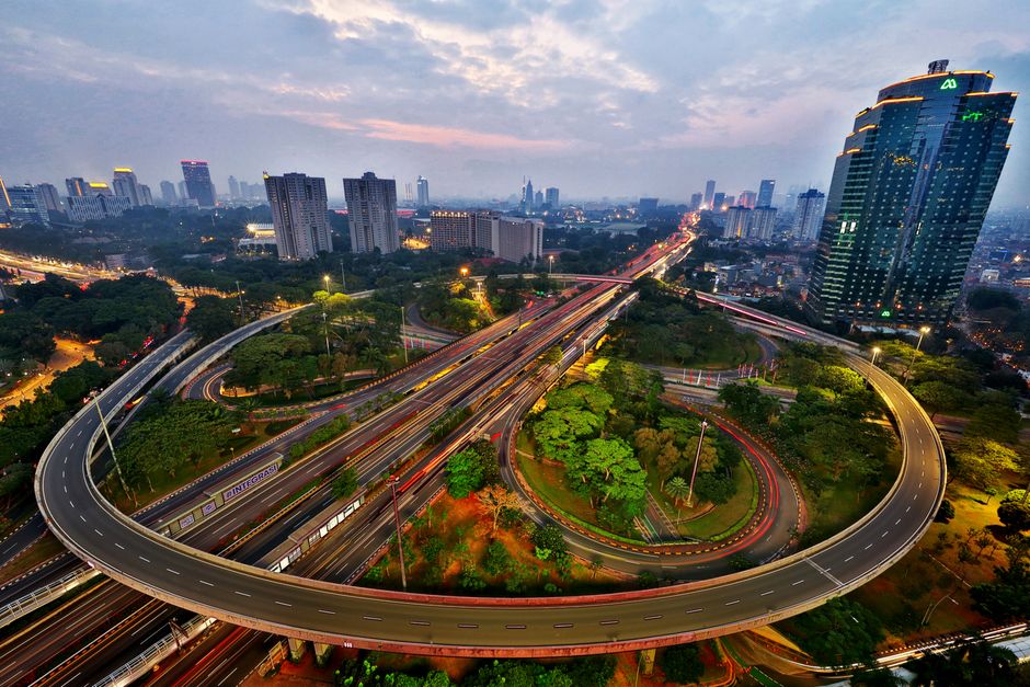 Mobilidade Urbana — Stunning aerial view of Jakarta's busy highway interchange illuminated at dusk.